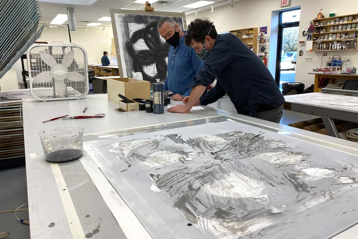 Wyatt Kahn and printer Bruce Wankel working on drawings for litho plates.